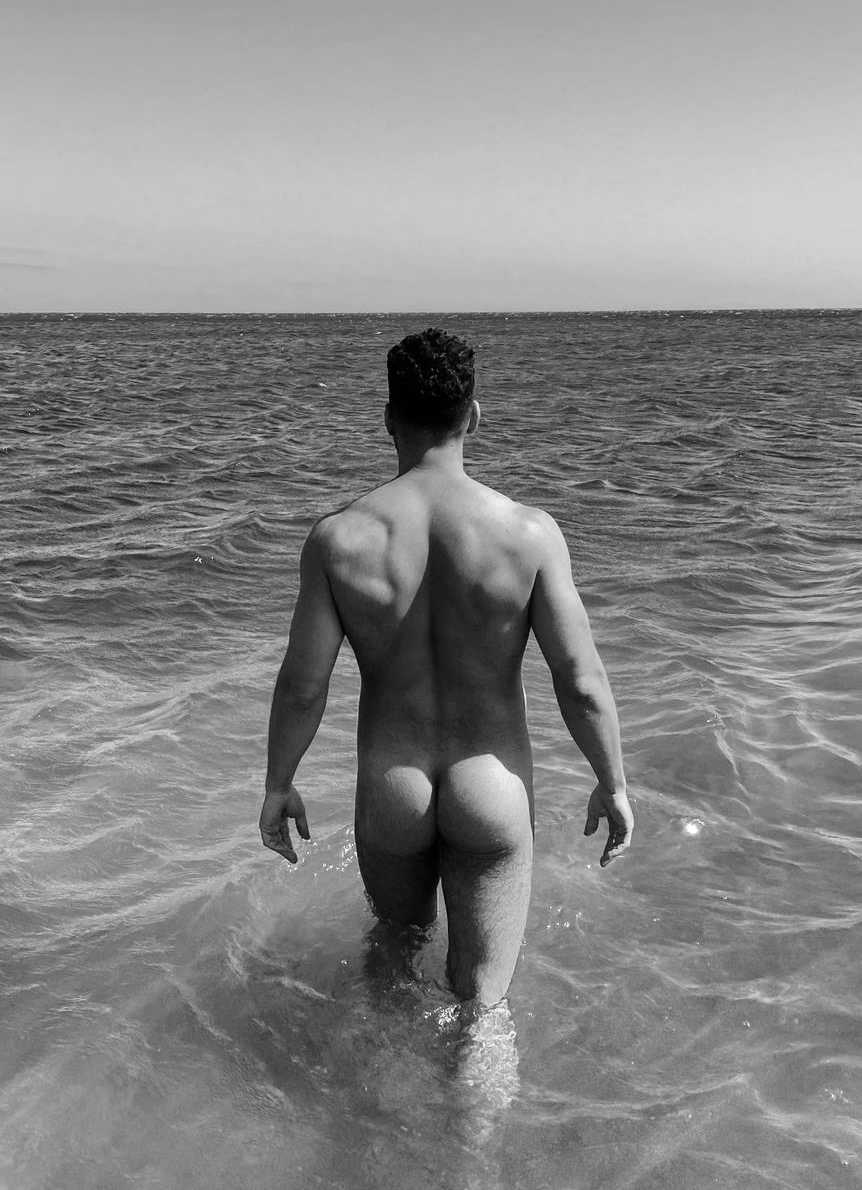 Entering the sea in Tenerife, seen from behind, in an artistic black-and-white nude. Alexander, gentleman companion.