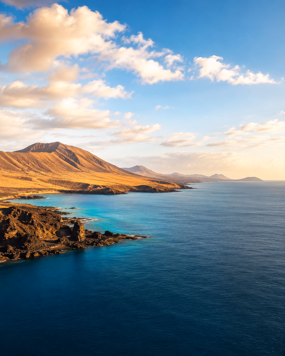 Volcanic coast and turquoise sea in the Canary Islands at sunset. The horizon awaiting you and your escort across the islands.